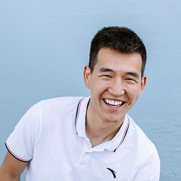 Male student smiling in front of camera