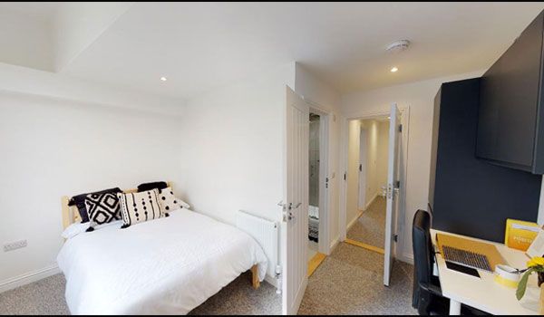 Bedroom with TV screen and table Manners Road James Oliver Properties