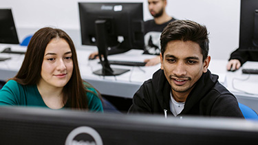 Students watching on the computer screen in the classroom