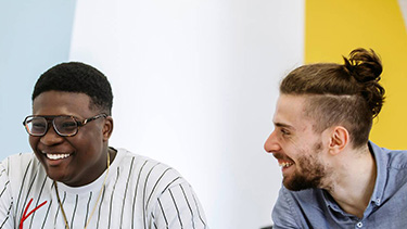 Students talking and smiling in the campus