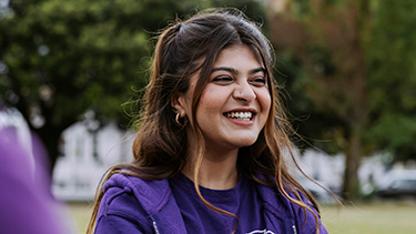Female student smiling in the campus garden