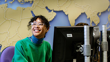 Two students talking in the computer lab