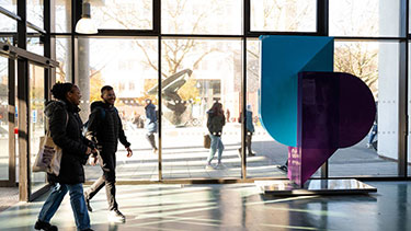 Students walking through university corridor