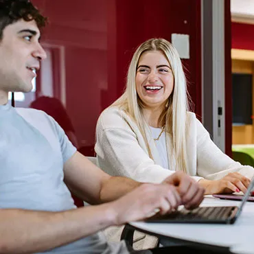 Male and female student sudying and socialising