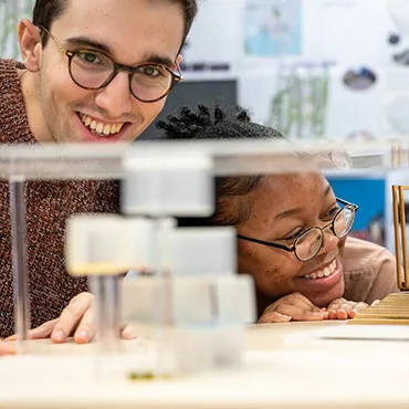 Male and female students working on a practical project