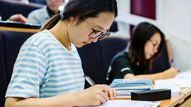 Female student writing on notebook