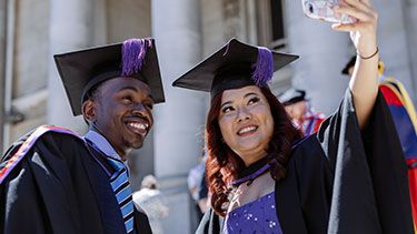Students graduating and taking a selfie