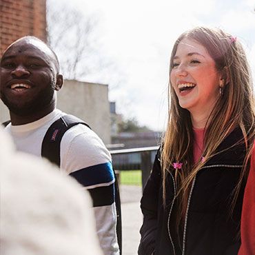 Students walking and smiling on campus