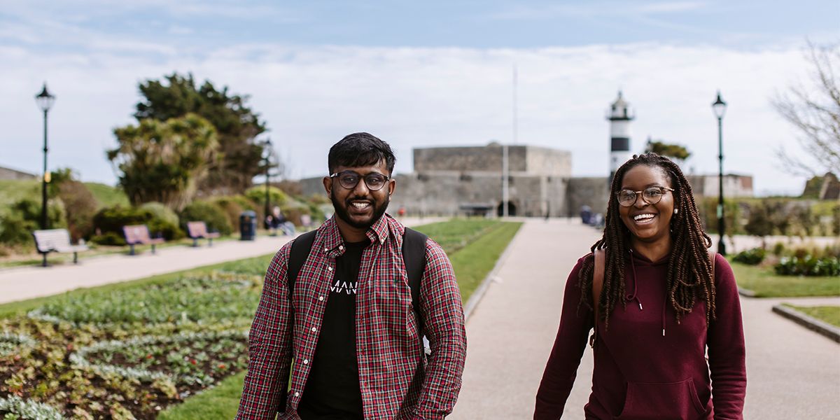 Male and female student walking in Portsmouth