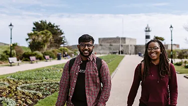 Male and female student walking in Portsmouth