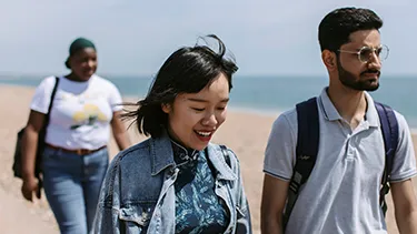 students walking on Portsmouth beach