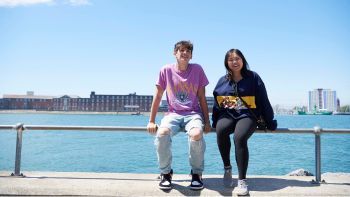 Students sitting at the seafront